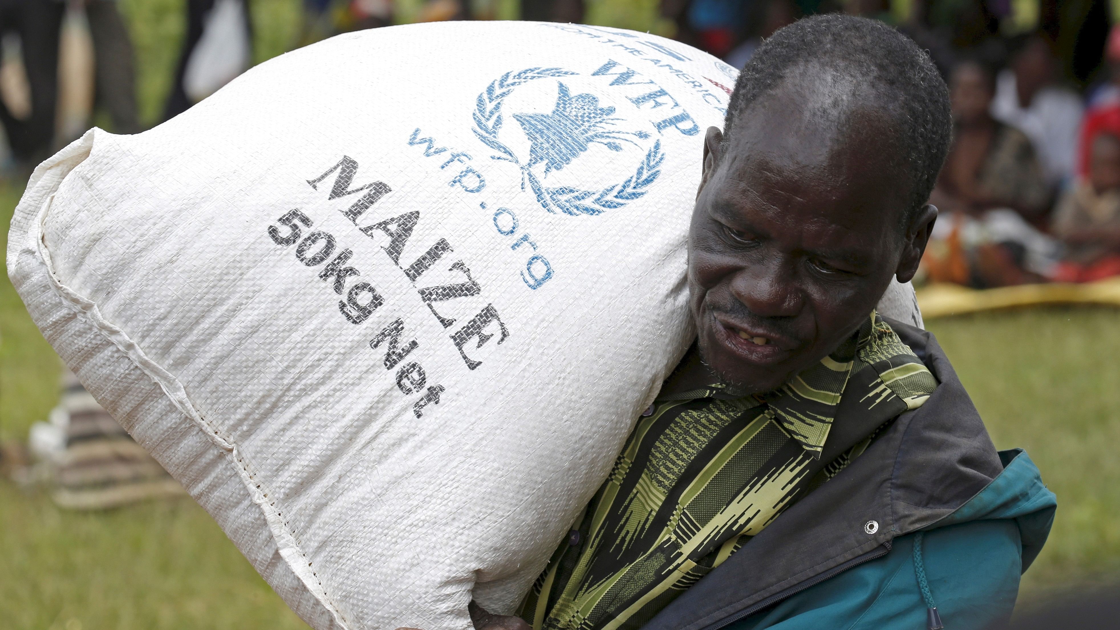 <div class="paragraphs"><p>File photo of a Malawian man carrying food aid </p></div>